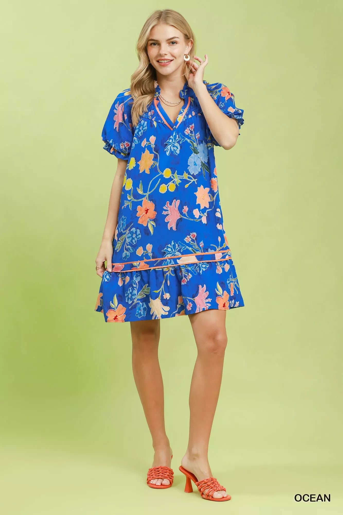Umgee floral ruffle hem mini dress with a feminine design, featuring a vibrant floral pattern and ruffled hem detail.