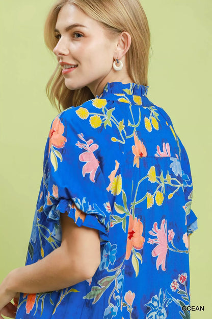 Umgee floral ruffle hem mini dress featuring a vibrant floral pattern and feminine ruffle details, perfect for casual or summer wear.