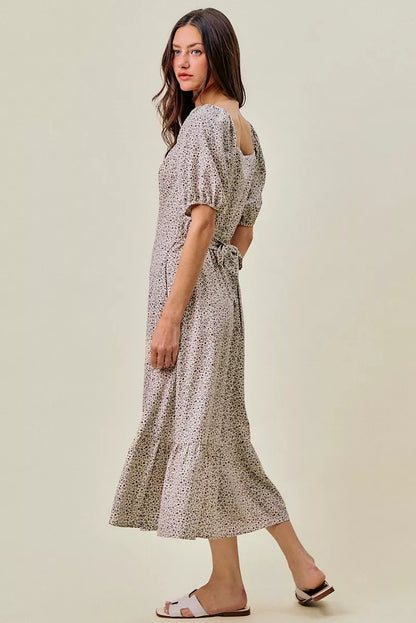Off-white and black SO ME ditsy floral maxi dress with self-belt and elastic waist from Trendsi, displayed on a hanger.