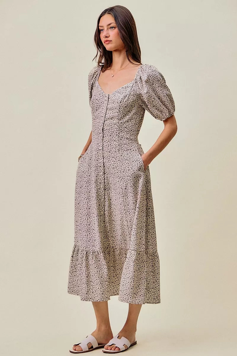 Off-white and black SO ME ditsy floral maxi dress with self-belt and elastic waist, by Trendsi, shown on a model.