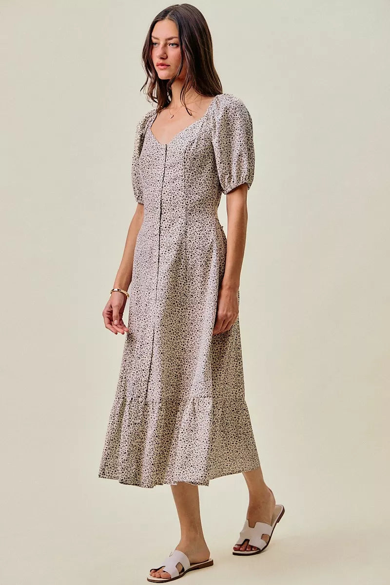 Off-white and black SO ME Ditsy Floral Maxi Dress by Trendsi with self-belt and elastic waistband, featuring a floral pattern.