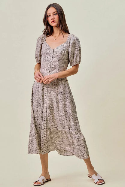 Off-white and black ditsy floral maxi dress with self belt and elastic waist from SO ME by Trendsi, shown on a model.