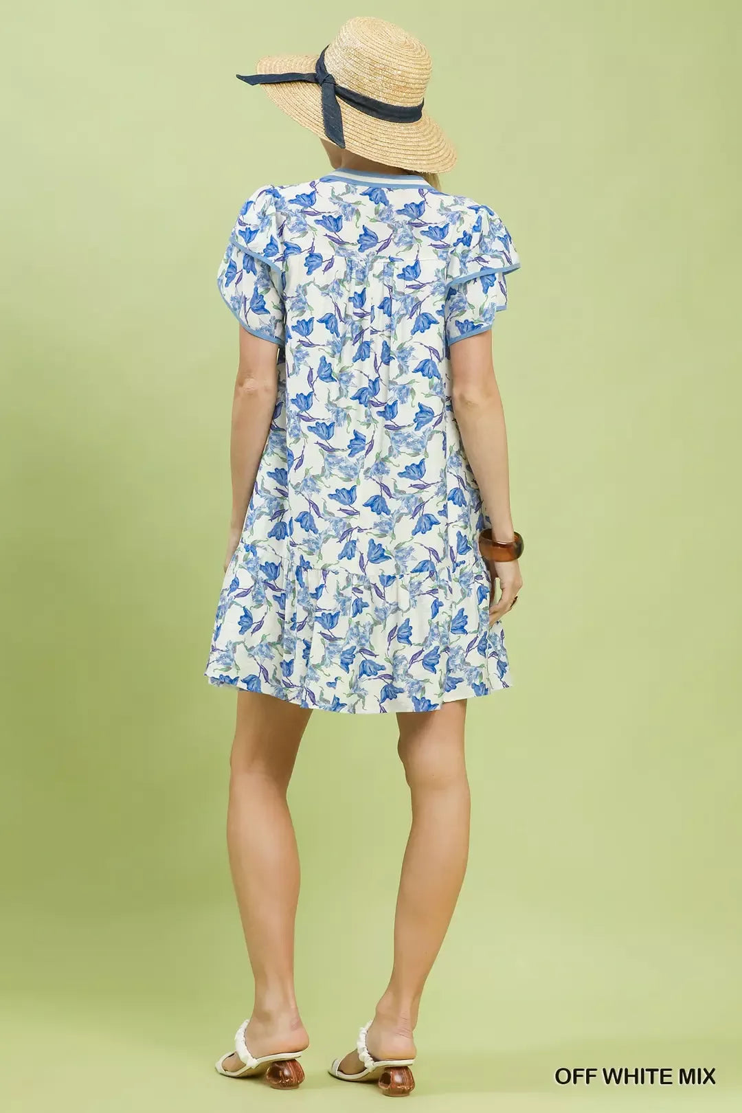 Off-white Umgee floral tiered dress with flutter sleeves, featuring a feminine and flowy design perfect for spring and summer.