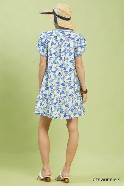Off-white Umgee floral tiered dress with flutter sleeves, featuring a feminine and flowy design perfect for spring and summer.