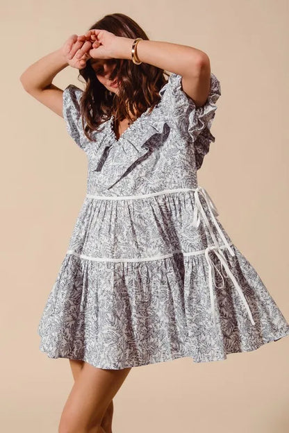 Off-white navy cotton printed ruffle V-neck dress with side tie, trendy and lightweight for casual or summer wear.