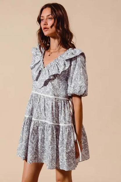Off-white navy cotton printed ruffle V-neckline dress with side tie by Trendsi, featuring a stylish and feminine design.