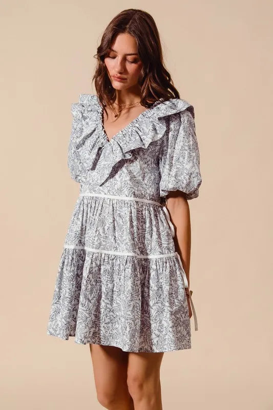 Off-white navy cotton printed ruffle V-neckline dress with side tie from Trendsi, featuring a stylish and comfortable design.