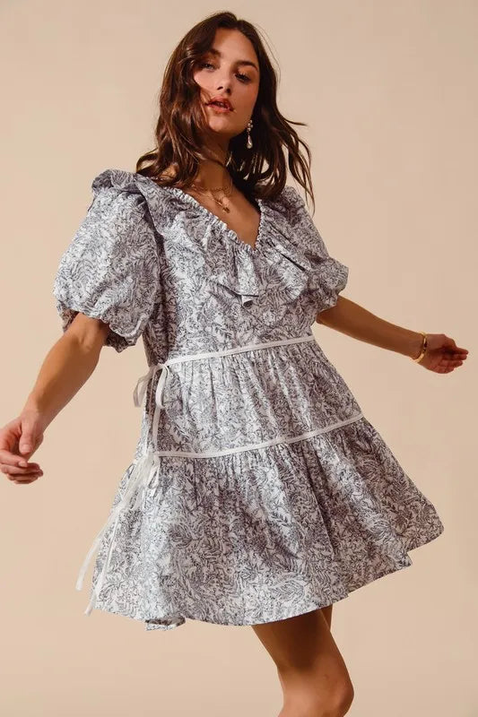 Off-white and navy SO ME cotton printed ruffle V-neck dress with side tie, featuring feminine ruffle details and a relaxed fit.