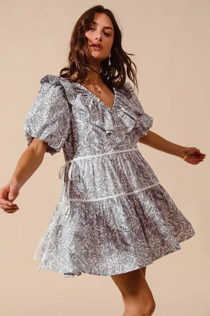 Off-white and navy SO ME cotton printed ruffle V-neck dress with side tie, featuring feminine ruffle details and a relaxed fit.