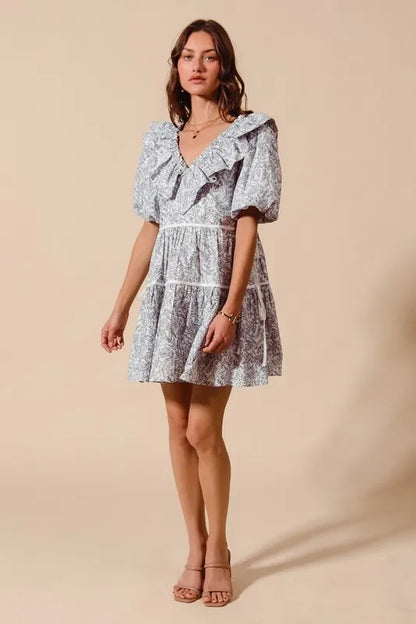 Off-white navy cotton printed ruffle V-neckline dress with side tie from Trendsi, stylish and lightweight for casual wear.