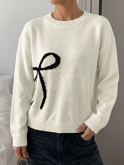 Off-white Bow Graphic Round Neck Sweater by Trendsi, featuring a stylish bow graphic design on a cozy knit fabric.
