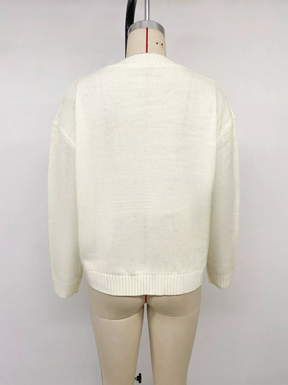 Off-white Bow Graphic Round Neck Sweater by Trendsi, featuring a cute bow graphic design on a cozy knit fabric.