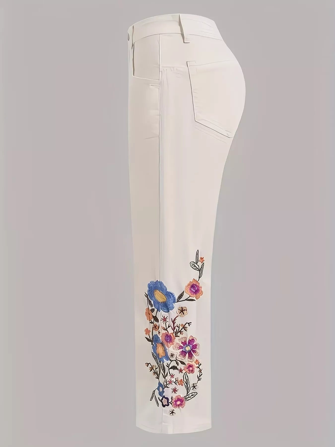 Off-white embroidered floral wide-leg jeans from Trendsi, featuring detailed floral embroidery and a relaxed fit.