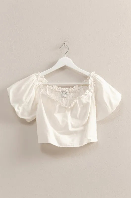 Off-white HYFVE puff sleeve sweetheart neck top with fitted bodice and ruffled sleeves, shown on a model.