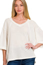 Off-white Zenana brushed waffle 3/4 sleeve top with exposed seams, featuring a relaxed fit and casual style.
