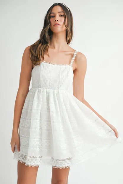 Off-white MABLE eyelet lace babydoll mini cami dress with delicate lace details and adjustable straps, perfect for casual wear.
