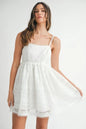 Off-white MABLE eyelet lace babydoll mini cami dress with delicate lace details and adjustable straps, perfect for casual wear.
