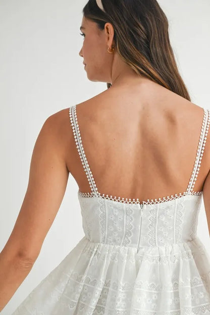 Off-white MABLE eyelet lace babydoll mini cami dress with spaghetti straps and delicate floral lace details.