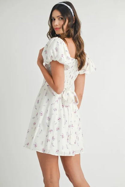 Off-white floral print puff sleeve mini dress by Trendsi, featuring a feminine silhouette and stylish design.