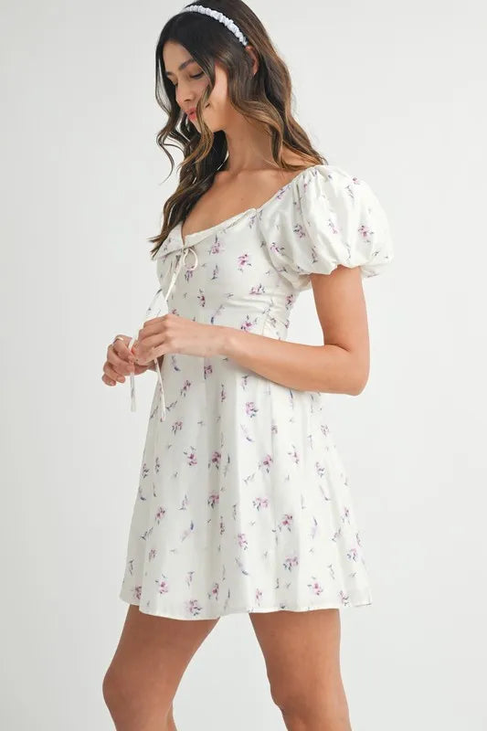 Off-white floral print puff sleeve mini dress by Trendsi, featuring a fitted bodice and short puff sleeves for a stylish look.