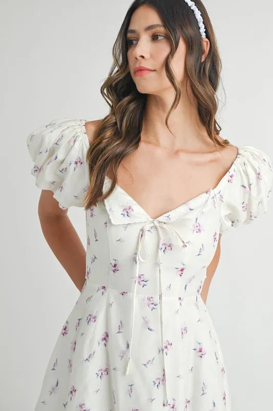 Off-white MABLE floral print puff sleeve mini dress by Trendsi, featuring a fitted bodice and short puff sleeves.