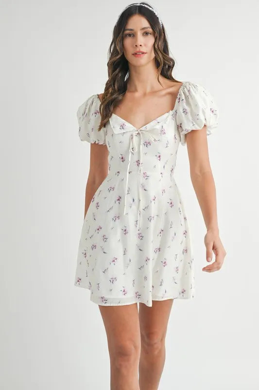 Off-white floral print puff sleeve mini dress by Trendsi featuring a fitted bodice and short puff sleeves.