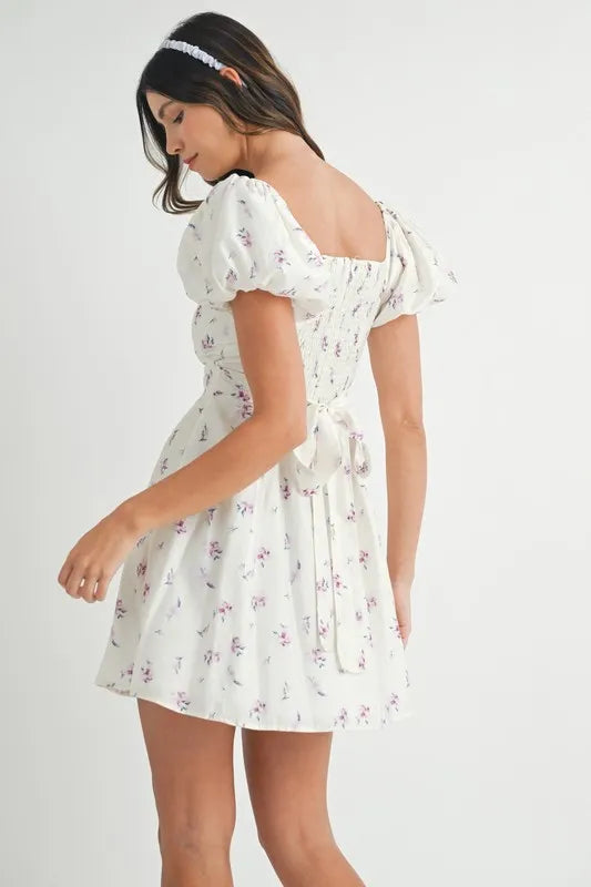 Off-white MABLE floral print puff sleeve mini dress by Trendsi, featuring a fitted bodice and short puff sleeves.