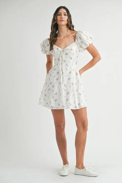 Off-white MABLE floral print puff sleeve mini dress with ruffled details, short length, and feminine design by Trendsi.