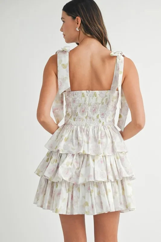 Off-white MABLE floral print shoulder tie layered mini dress by Trendsi, featuring a feminine design with floral pattern and layered skirt.