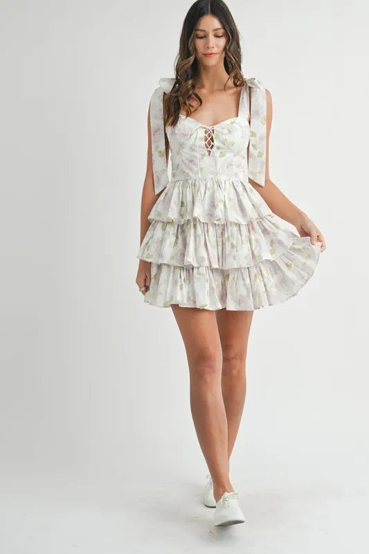 Off-white MABLE floral print shoulder tie layered mini dress by Trendsi, featuring a feminine floral pattern and layered design.