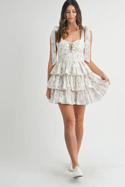 Off-white MABLE floral print shoulder tie layered mini dress by Trendsi, featuring a feminine floral pattern and layered design.