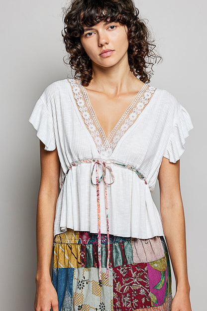Off-white POL Tied Ruffled V-Neck Short Sleeve Blouse with Lace Detail from Trendsi, featuring delicate ruffles and lace accents.