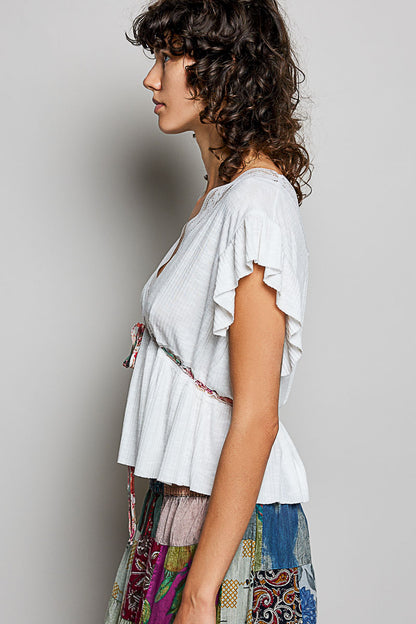 Off-white Trendsi POL tied ruffled V-neck short sleeve blouse with lace detail, showcasing elegant design and feminine style.