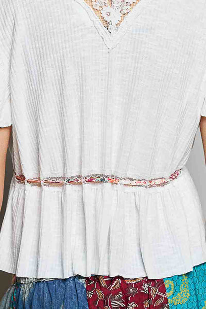 Off-white Trendsi POL tied ruffled V-neck short sleeve blouse with lace detail, showcasing elegant feminine style.