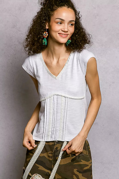 Off-white Trendsi V-neck lightweight textured knit top with short sleeves and delicate lace trim, perfect for casual or dressy wear.