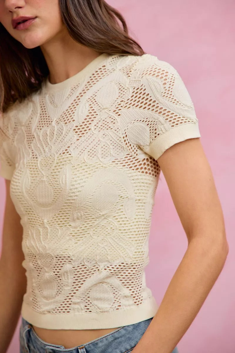 Off-white SO ME floral perforated seamless active short sleeve top by Trendsi, lightweight breathable athletic shirt.