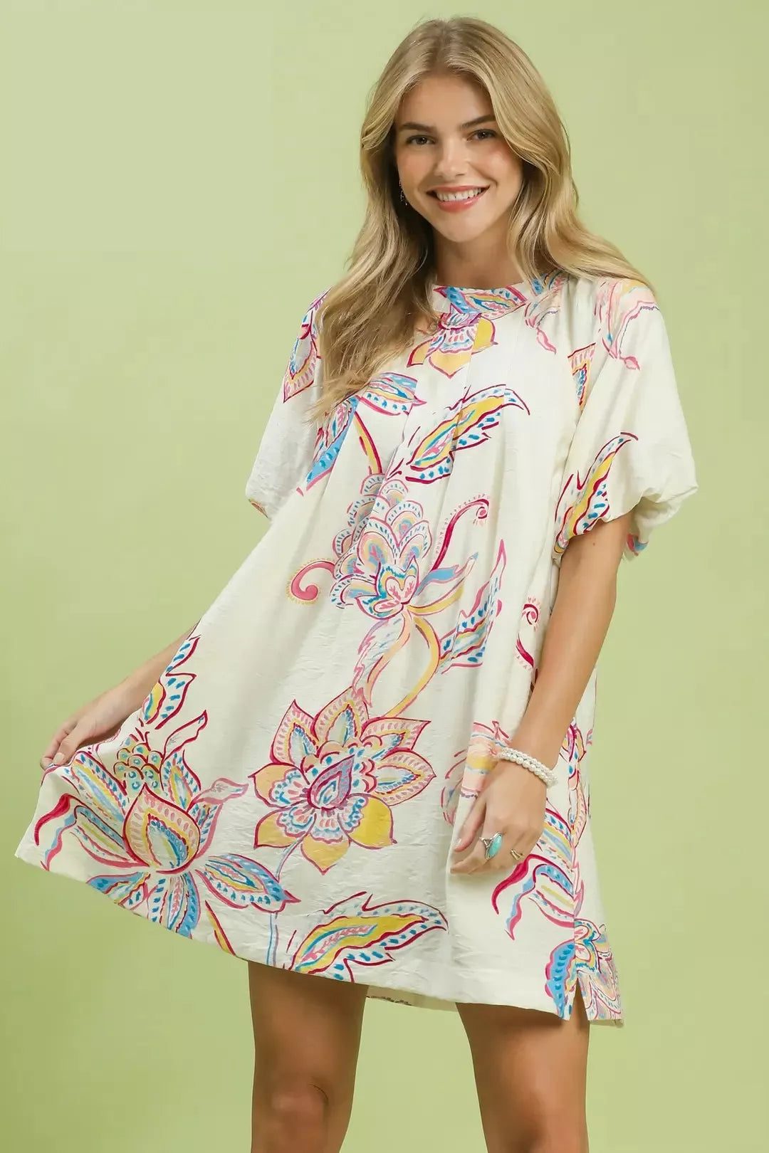 Off-white Umgee boho floral print mini dress with pockets, featuring a relaxed fit and casual summer style.