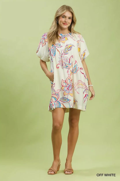 Off-white Umgee boho floral print mini dress with pockets, featuring a relaxed fit and casual style.