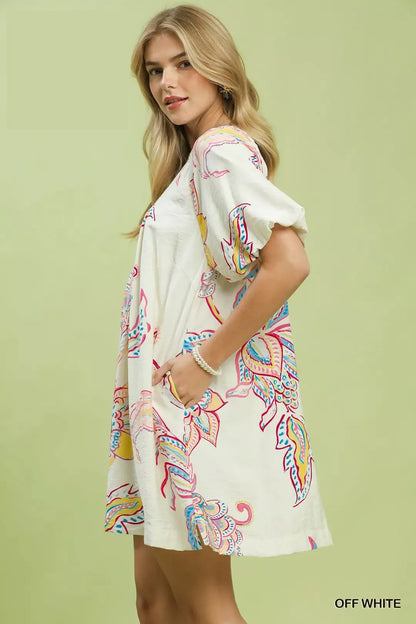 Off-white Umgee boho floral print mini dress with pockets, featuring a relaxed fit and lightweight fabric for casual wear.