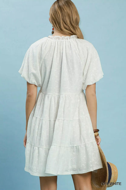 Off-white Umgee Jacquard Puff Sleeve Mini Dress with detailed pattern and feminine silhouette, styled for casual or dressy occasions.