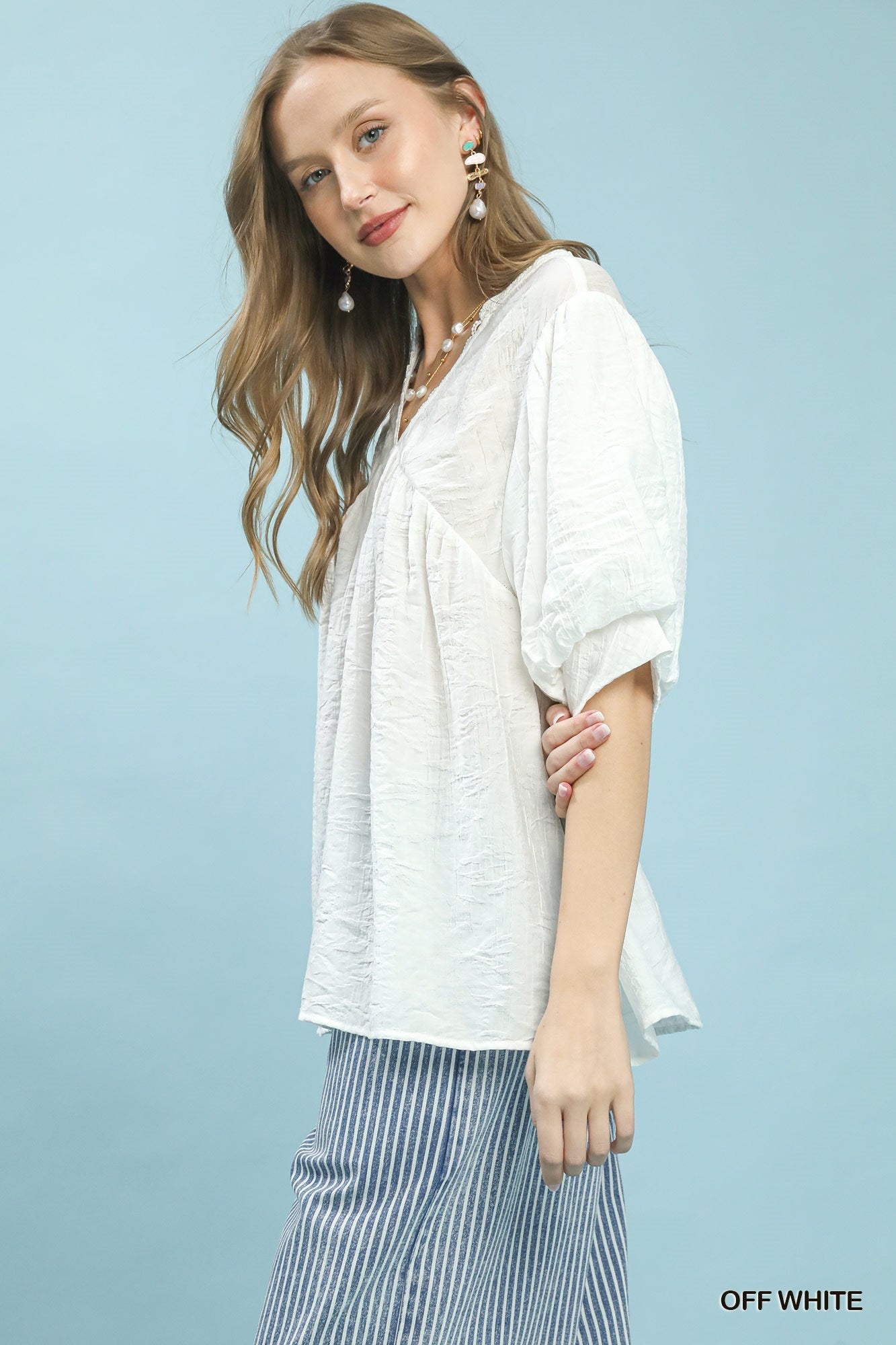 Off-white Umgee boho blouse with textured lace trim, V-neck style, and relaxed fit, perfect for casual and bohemian outfits