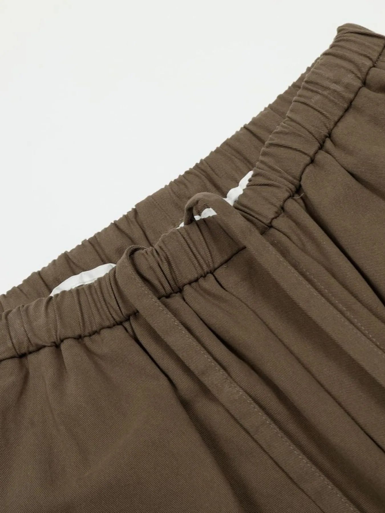Men's olive brown wide leg drawstring pants with elastic waistband and relaxed fit, from Trendsi.
