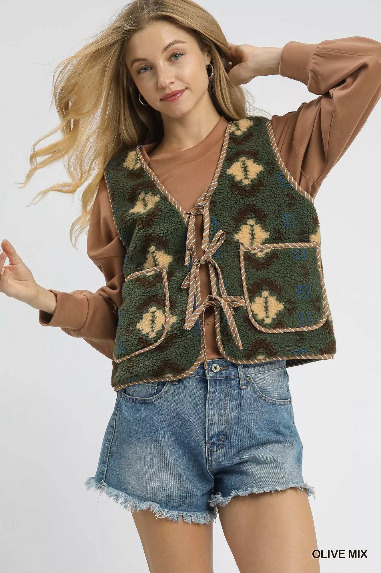 Olive green Umgee mix patterned sherpa tie-front vest with cozy textured fabric and stylish front tie detail.