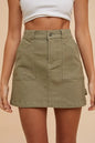 Olive green Annie Wear cargo denim mini skirt with side pockets, styled for casual wear, by Trendsi.