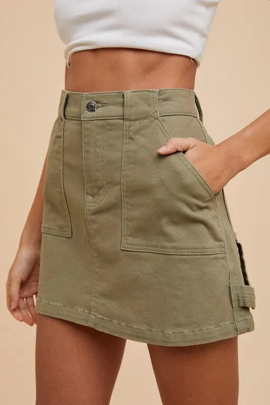 Olive green Annie Wear cargo denim mini skirt with side pockets, stylish and casual for trendy everyday wear.