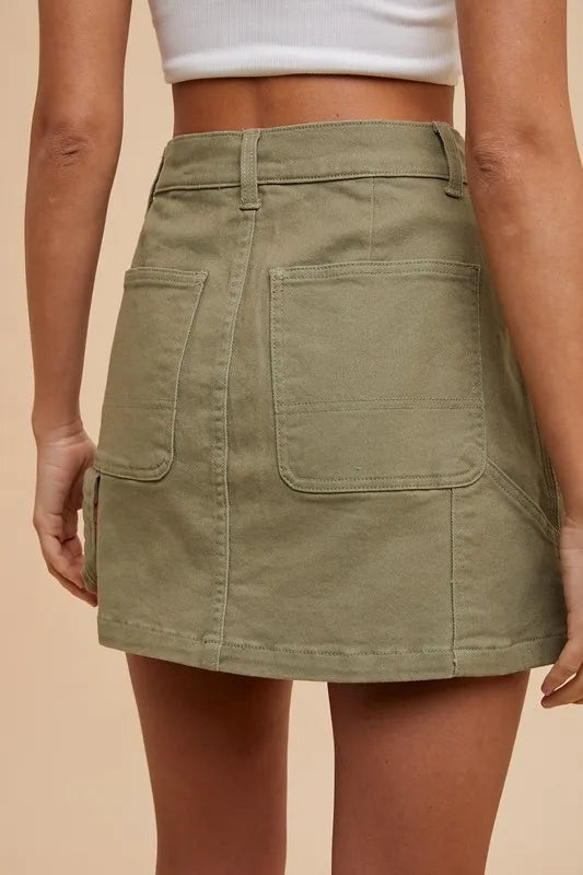 Olive green Annie Wear cargo denim mini skirt by Trendsi, featuring multiple pockets and a casual, stylish fit.