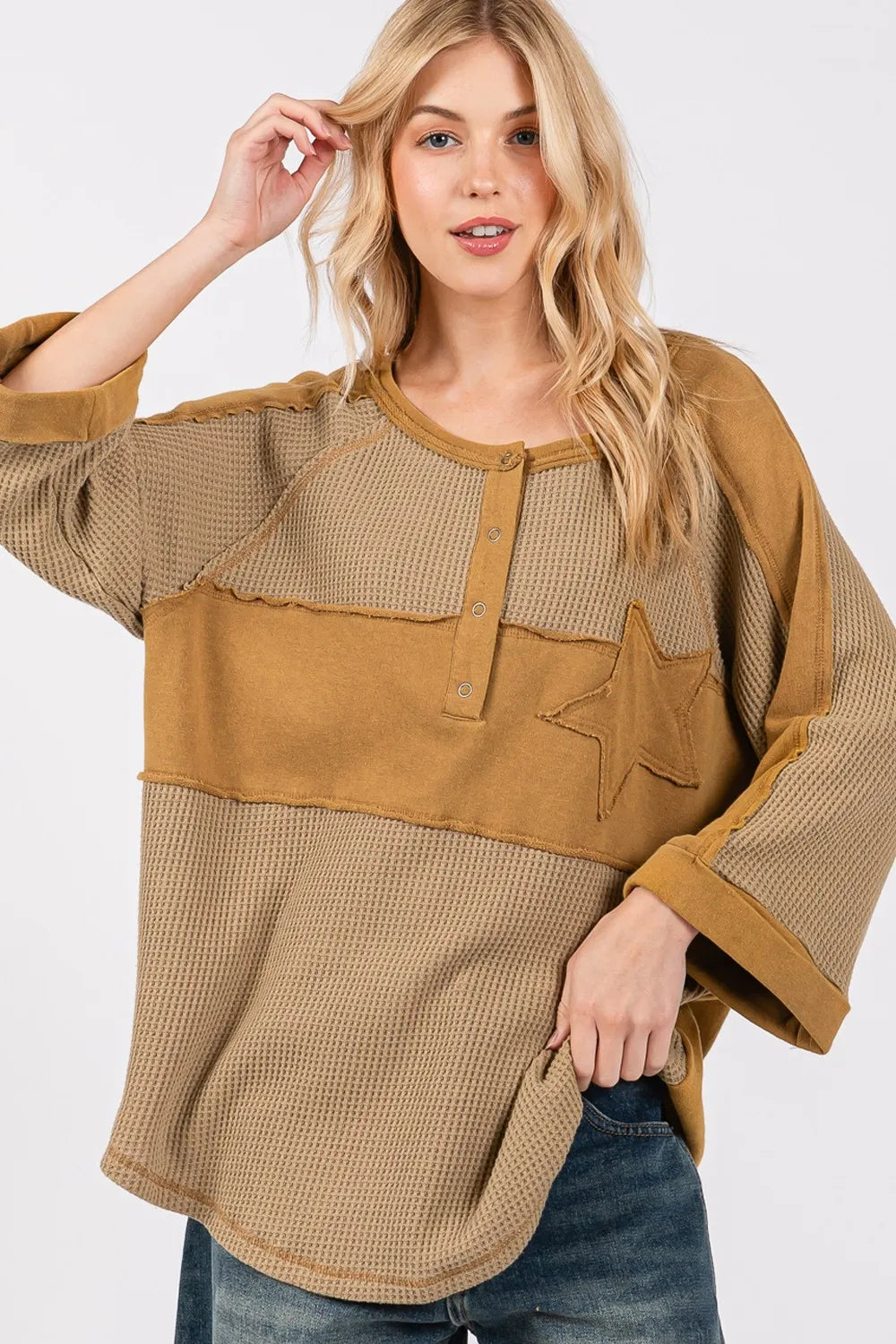 Olive green waffle knit top with sage and fig star applique patches and exposed seam detail, by Trendsi.