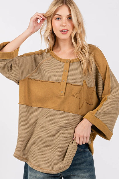 Olive green waffle knit top with sage and fig star applique patches and exposed seam detail, by Trendsi.