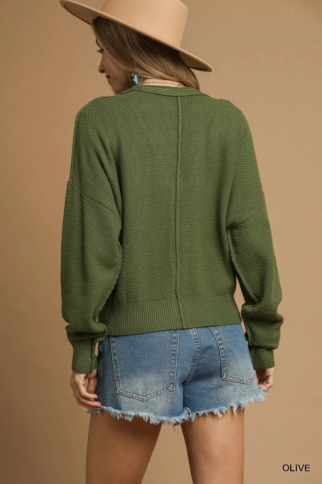 Olive green Umgee chunky cable knit V-neck button-up cardigan with long sleeves and ribbed trim, stylish and cozy for fall.