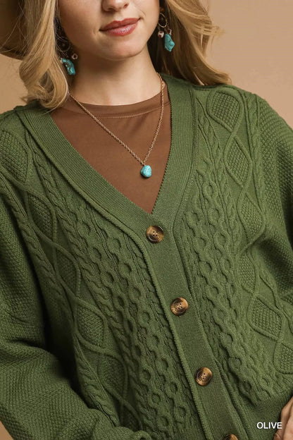 Olive green Umgee chunky cable knit V-neck button-up cardigan with long sleeves and ribbed cuffs, featuring front buttons.